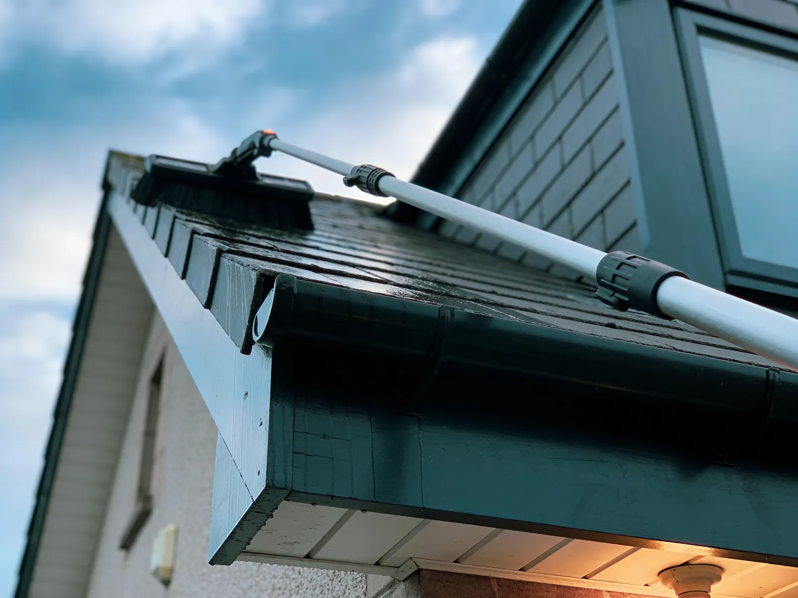 High-level gutter and fascia cleaning with a pole vacuum