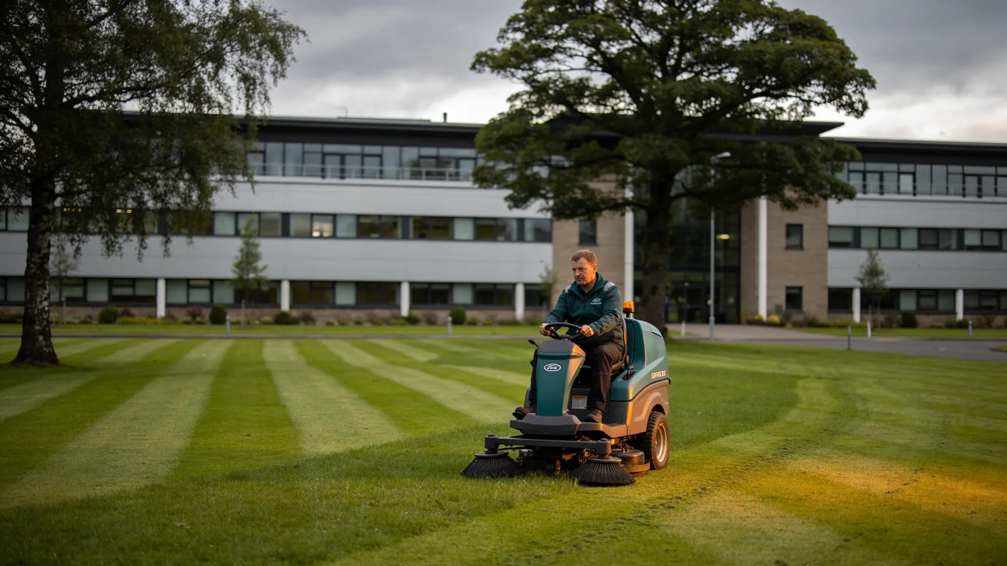 Striped lawns of a Scottish corporate campus being mown